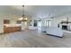 Open living room with wood floors, fireplace, and chandelier, creating an inviting atmosphere at 6915 E Gary Rd, Scottsdale, AZ 85254