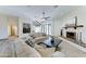 Comfortable living room with a decorative fireplace, wood-look floors, and neutral-toned furniture at 6915 E Gary Rd, Scottsdale, AZ 85254