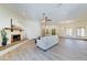 Open living area with a decorative fireplace, neutral furniture, and wood-look flooring at 6915 E Gary Rd, Scottsdale, AZ 85254