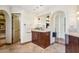 Main bathroom with a dark wood vanity, tile floor and countertops, and an arched entry at 6915 E Gary Rd, Scottsdale, AZ 85254