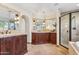 Spacious main bathroom with double vanity, tiled countertops, walk-in shower and an arched entry at 6915 E Gary Rd, Scottsdale, AZ 85254