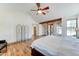 Main bedroom featuring hardwood floors, ceiling fan, fireplace, and French doors to backyard at 6915 E Gary Rd, Scottsdale, AZ 85254