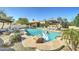 Inviting pool and patio area with waterfall, lounge chairs, and a decorative swan float at 6915 E Gary Rd, Scottsdale, AZ 85254