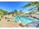 Sparkling pool with a swan floatie and waterfall feature, surrounded by desert landscaping and lounge chairs at 6915 E Gary Rd, Scottsdale, AZ 85254