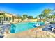 Inviting pool and patio area with waterfall, lounge chairs, and a decorative swan float at 6915 E Gary Rd, Scottsdale, AZ 85254