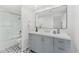 Bright bathroom featuring gray vanity with white quartz countertop, and a framed mirror over a tiled floor at 7209 E Mcdonald Dr # 51, Scottsdale, AZ 85250