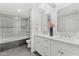 Well-lit bathroom featuring a dual vanity, a glass shower door, and light fixtures for illumination at 7209 E Mcdonald Dr # 51, Scottsdale, AZ 85250