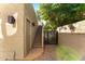 Exterior view featuring stairs and a gate, complemented by stylish lighting fixtures on textured walls at 7209 E Mcdonald Dr # 51, Scottsdale, AZ 85250