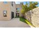 Exterior of home showing a patio area, stucco walls, and an artificial grass lawn, providing curb appeal at 7209 E Mcdonald Dr # 51, Scottsdale, AZ 85250