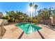 Community pool area with sun loungers, surrounded by trees and palm trees on a sunny day at 7209 E Mcdonald Dr # 51, Scottsdale, AZ 85250