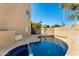 Backyard featuring a sparkling blue pool with a tiled spa, set against a stucco wall at 7209 E Mcdonald Dr # 51, Scottsdale, AZ 85250