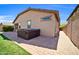 Backyard patio featuring a hot tub and brick pavers, perfect for outdoor relaxation at 7576 W Fetlock Trl, Peoria, AZ 85383