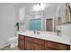 Modern bathroom with wood cabinets, a white countertop, and a large mirror over the sink at 7576 W Fetlock Trl, Peoria, AZ 85383