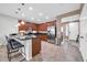 Bright kitchen featuring dark granite countertops, stainless steel appliances, cherry-wood cabinetry, and island seating at 7576 W Fetlock Trl, Peoria, AZ 85383