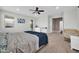 Bedroom featuring a large bed, carpeted floor, ceiling fan, and a view to the outdoor patio and landscape at 7576 W Fetlock Trl, Peoria, AZ 85383