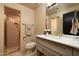 Vintage-style bathroom with a walk-in shower featuring brass hardware and a marble countertop at 8233 E Foothill Cir, Scottsdale, AZ 85255