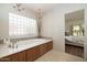 Elegant bathroom features a large soaking tub, a chandelier, and a window at 8233 E Foothill Cir, Scottsdale, AZ 85255