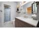 Modern bathroom with stylish tiles in the shower, shaker cabinets, and a large mirror at 8233 E Foothill Cir, Scottsdale, AZ 85255