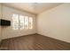 Neutral bedroom features wood-look floors, recessed lighting, and window with shutters at 8233 E Foothill Cir, Scottsdale, AZ 85255