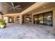 Expansive covered patio featuring travertine flooring, ceiling fans, and seamless indoor-outdoor flow at 8233 E Foothill Cir, Scottsdale, AZ 85255