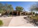 Beautiful southwestern style home with a circular drive and desert landscaping at 8233 E Foothill Cir, Scottsdale, AZ 85255