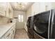 Beautiful laundry room boasts marble countertops, shaker cabinets, and high-end washer and dryer at 8233 E Foothill Cir, Scottsdale, AZ 85255