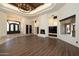 Bright living room with cozy fireplace, decorative niche lighting, and a coffered ceiling at 8233 E Foothill Cir, Scottsdale, AZ 85255