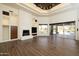 Open living room with a fireplace, built-ins, and sliding doors to the pool area at 8233 E Foothill Cir, Scottsdale, AZ 85255