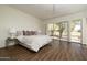 Spacious main bedroom with wooden floors and access to an outdoor view at 8233 E Foothill Cir, Scottsdale, AZ 85255