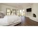 Light-filled bedroom with outdoor views, a ceiling fan, and a fireplace at 8233 E Foothill Cir, Scottsdale, AZ 85255