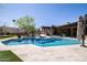 Beautiful backyard pool, travertine tile, and desert landscaping create a private and serene outdoor oasis at 8233 E Foothill Cir, Scottsdale, AZ 85255