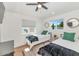 Well-lit bedroom with two twin beds, a window, neutral decor, and wood-look flooring at 92 N Palm St, Gilbert, AZ 85234