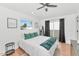 Bedroom with natural light, white bedding, and a sliding glass door to outdoor space at 92 N Palm St, Gilbert, AZ 85234