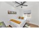 Bright bedroom with a Queen bed, soft lighting, white walls, and wood-look flooring at 92 N Palm St, Gilbert, AZ 85234