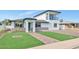 Inviting home exterior with a green lawn, brick driveway, and a stylish two-story design at 92 N Palm St, Gilbert, AZ 85234