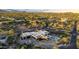 An aerial view of a contemporary home featuring a swimming pool and beautiful desert landscaping in a serene community at 10354 E Celestial Dr, Scottsdale, AZ 85262