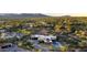 Aerial view of a modern home with a pool, set within desert landscaping in a quiet community with scenic mountain views at 10354 E Celestial Dr, Scottsdale, AZ 85262