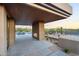 A covered patio with an outdoor fireplace, pool, and desert landscaping at 10354 E Celestial Dr, Scottsdale, AZ 85262