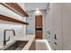 Modern bar area has wood floating shelves and additional kitchen storage at 10354 E Celestial Dr, Scottsdale, AZ 85262