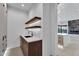 Custom bar area has a sink and floating shelves with wood accents at 10354 E Celestial Dr, Scottsdale, AZ 85262