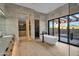 Luxury bathroom features soaking tub, marble accents, and seamless indoor-outdoor flow at 10354 E Celestial Dr, Scottsdale, AZ 85262