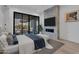 Comfortable bedroom featuring a stone accent wall with fireplace and doors to outdoor patio at 10354 E Celestial Dr, Scottsdale, AZ 85262