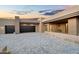 Home exterior with a long driveway leading to a two-car garage, highlighted by desert landscaping at 10354 E Celestial Dr, Scottsdale, AZ 85262