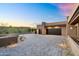 Paver driveway leads to a modern home with a spacious three-car garage and desert landscaping at 10354 E Celestial Dr, Scottsdale, AZ 85262