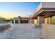 Paver driveway leads to a modern home with a spacious three-car garage and desert landscaping at 10354 E Celestial Dr, Scottsdale, AZ 85262