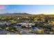Aerial view of home with a circular drive and mountain views in distance at 10354 E Celestial Dr, Scottsdale, AZ 85262