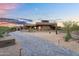 Beautiful modern home featuring desert landscaping and a brick driveway under a colorful evening sky at 10354 E Celestial Dr, Scottsdale, AZ 85262
