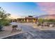 Beautifully landscaped front yard with a paver driveway leading to a modern desert home with a sign at 10354 E Celestial Dr, Scottsdale, AZ 85262