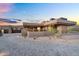 Contemporary home with desert landscaping, paver driveway, and multiple windows for natural light at 10354 E Celestial Dr, Scottsdale, AZ 85262