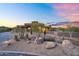 Landscaped desert home with rocks and cacti, featuring modern design and desert plants at 10354 E Celestial Dr, Scottsdale, AZ 85262